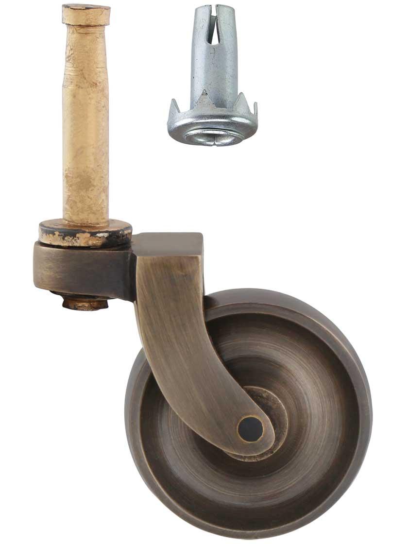 Casters |   Large Brass Grip-Neck Caster with 1 1/2″ Brass Wheel in Antique-By-Hand Casters Casters